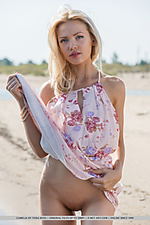 Camelia new model camelia sensually strips at the beach as she bares her petite body.