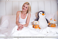 Zazie gorgeous blonde zazie playfully strips on the bed.